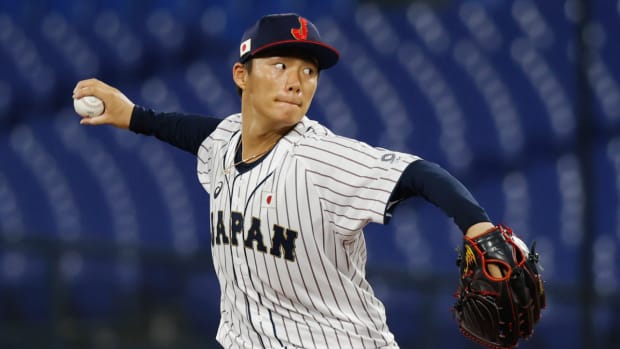 Japanese pitcher Yoshinobu Yamamoto throws a pitch during the 2020 Tokyo Olympics.